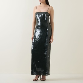 Model wearing Rotate Black Olive sequin maxi dress with spaghetti straps and slim silhouette, styled with black heeled sandals.