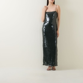 Model wearing Rotate Black Olive sequin maxi dress with thin straps and fitted silhouette, styled with black strappy heels