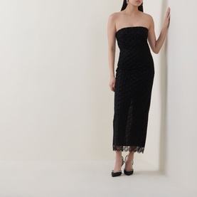Model wearing Rotate black strapless midi dress with lace hem and textured fabric, styled with black pointed-toe heels