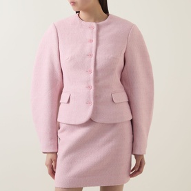 Model wearing Rotate Cherry Blossom textured boucl&eacute; jacket with matching mini skirt, round neck, flap pockets, and button front fastening.