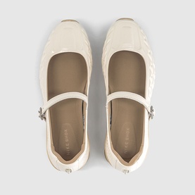 Cream quilted leather Mary Jane ballet flats with silver buckle strap, viewed from above, rubber sole visible at edges