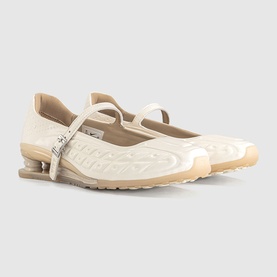Cream patent leather Mary Jane flats with embossed logo detailing, single ankle strap, and translucent rubber sole