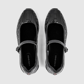 Nike Shox Z Calistra Ballet Flats in black patent-effect synthetic leather, top-down view showing adjustable ankle strap and hook-and-loop fastening