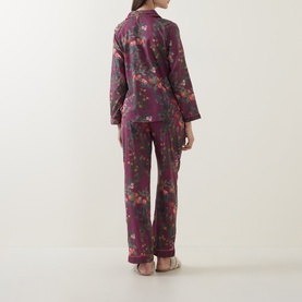 Model wearing Their Nibs Plum floral cotton pyjamas, back view showing long-sleeve shirt and wide-leg trousers