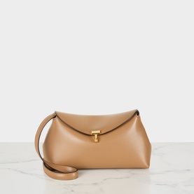 Toteme T-Lock Leather Clutch in camel smooth leather with gold-tone T-lock clasp, flap closure, and removable shoulder strap.