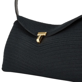 Toteme T-Lock Rope Clutch in black with gold-tone T-lock flap closure, woven rope texture, and single shoulder strap visible.