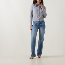 Model wearing Ulla Johnson Anna Embellished Cardigan in ash, sequin-embellished collar, styled with blue wide-leg jeans and heeled sandals.