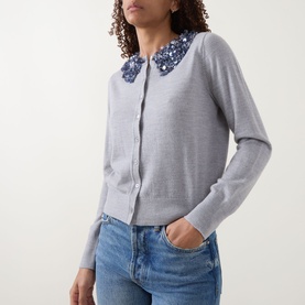 Model wearing Ulla Johnson Anna Embellished Cardigan in ash grey with sequin-embellished collar, styled with blue jeans.