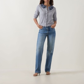 Model wearing Ulla Johnson Anna Embellished Cardigan in Ash with sequin collar, paired with light blue wide-leg jeans and strappy heeled sandals.