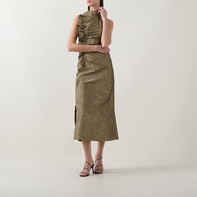 Model wearing Ulla Johnson Demetria Ruched Dress in Light Gold, sleeveless midi with mock neck and ruched bodice, styled with strappy heeled sandals
