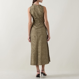 Model wearing Ulla Johnson Demetria Ruched Dress in light gold, showing rear view of sleeveless midi-length crinkle taffeta silhouette with black