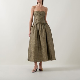Model wearing Ulla Johnson Lumina Textured Gown in Light Gold, strapless sweetheart neckline, ruched bustier, full midi skirt in crinkle taffeta