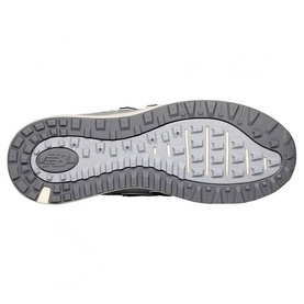 New Balance Golf women's golf shoe sole in Sand Pink, showing textured grey rubber outsole with traction lugs and New Balance branding.