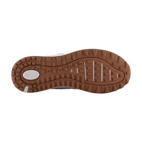 New Balance Golf womens golf shoe in white, sole view showing tan rubber outsole with multi-directional traction lugs