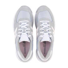 New Balance trainers in pale grey and white, featuring suede and mesh panels, white laces, and a chunky white sole, top-down view.