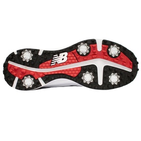 New Balance Golf men's golf shoe sole in white and black with red outsole and silver spike cleats visible.
