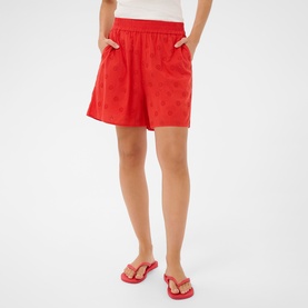 Model wearing Kaffe Poppy Red shorts with elasticated waist and side pockets, styled with red floral flip flops