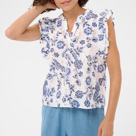 Model wearing Kaffe top in Chalk Midnight Flower, white broderie anglaise with blue floral print, ruffle sleeves and V-neckline, styled with blue