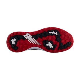 Red and black textured rubber outsole of a New Balance trainer, showing camo-pattern grip lugs and embossed NB logo.