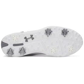 White Under Armour golf shoe sole with grey UA logo, metal cleats, and traction pods visible across outsole.