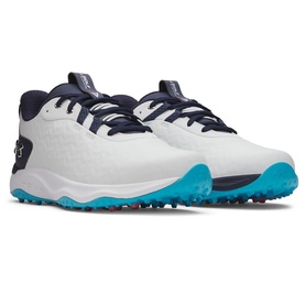 Under Armour golf shoes in white with navy laces and accents, teal spiked outsole, low-top lace-up style