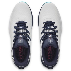 Top-down view of white and navy Under Armour golf shoes with teal accent lacing, showing cushioned insole and rubber outsole detail