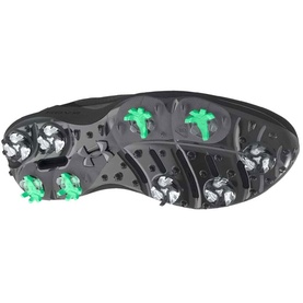 Black golf shoe outsole with white and green cleats, featuring Under Armour logo and multi-cleat traction pattern.