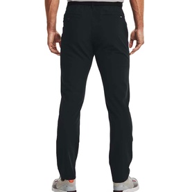 Model wearing Under Armour black slim-fit trousers, rear view showing back pockets and tapered leg