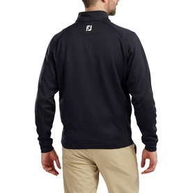 Model wearing black FootJoy quarter-zip pullover, rear view, styled with beige trousers