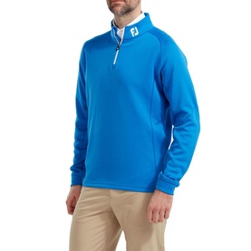 Model wearing Footjoy cobalt blue quarter-zip golf pullover with white zip placket, styled with beige trousers