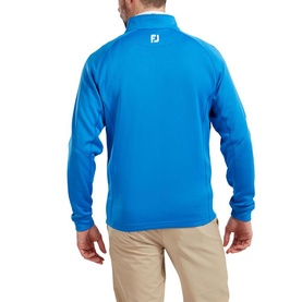 Model wearing Footjoy cobalt blue quarter-zip pullover top, rear view, styled with beige trousers