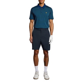 Model wearing Lyle & Scott Golf Dark Navy shorts, styled with a teal striped polo shirt and white trainers