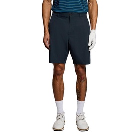 Model wearing Lyle & Scott Golf dark navy shorts, styled with a striped polo shirt and white trainers