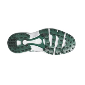 Green and white trainer outsole with multi-directional stud traction pattern and central arch bridge detail.