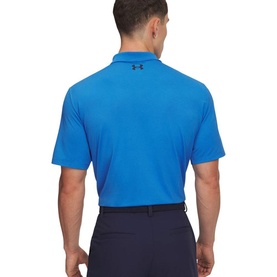Model wearing blue Under Armour polo shirt, rear view, styled with navy trousers. Short sleeves, logo detail at upper back.