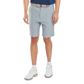 Model wearing Footjoy grey golf shorts with brown belt, styled with white golf shoes