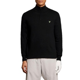 Model wearing Lyle & Scott Golf quarter-zip jumper in Jet Black, with embroidered eagle logo, styled with light grey trousers.