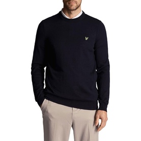 Model wearing Lyle & Scott Golf crew neck sweatshirt in Dark Navy, with gold eagle logo, styled with beige trousers.