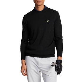 Model wearing black Lyle & Scott crew neck knit sweater with gold eagle logo, styled with white trousers and golf glove.