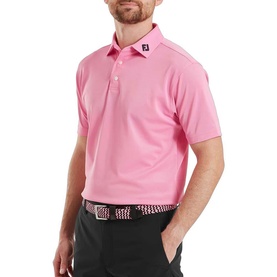 Model wearing FootJoy Pink Pop polo shirt with three-button placket, styled with black trousers and patterned belt.