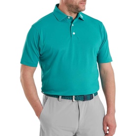 Model wearing Footjoy Tile Blue short-sleeve polo shirt, styled with light grey trousers and a patterned belt.