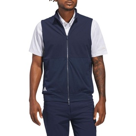 Model wearing Adidas Golf gilet in Collegiate Navy, zip-through design with stand collar, styled with white polo and navy trousers