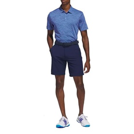Model wearing Adidas Golf Collegiate Navy men's chino shorts, styled with a blue marl polo shirt and white golf trainers.