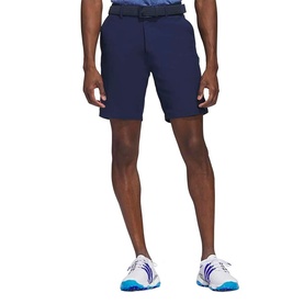 Model wearing Adidas Golf Collegiate Navy shorts with a belt, styled with white and blue trainers.
