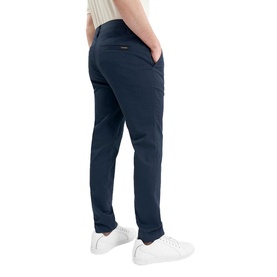 Model wearing Calvin Klein Golf navy slim-fit trousers, styled with white trainers, rear three-quarter view