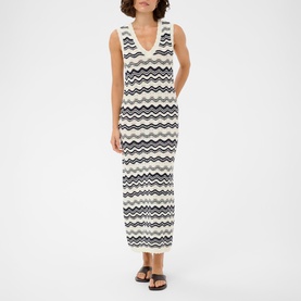 Model wearing Kaffe maxi dress in Chalk/Midnight wavy stripe knit, V-neck, sleeveless, styled with black flat sandals