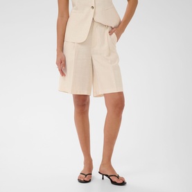 Model wearing Kaffe Feather Gray Melange tailored shorts with wide leg, styled with matching waistcoat and black strappy sandals.