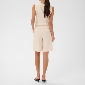 Model wearing Kaffe shorts in Feather Gray Melange with a matching sleeveless top and black heeled mules, rear view