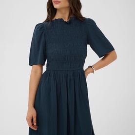 Model wearing Kaffe Midnight Marine smocked midi dress with puff sleeves, frilled neckline and gathered skirt.