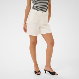 Model wearing Kaffe chalk white tailored shorts, styled with a striped top and black kitten heel mules, gold bracelet